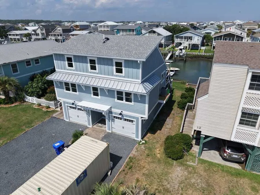 Aerial view of a renovated two-story canal-front home