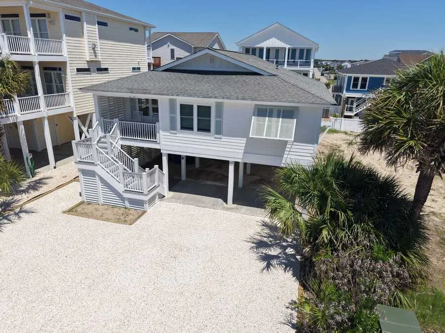 Raised white beach house with new stairs