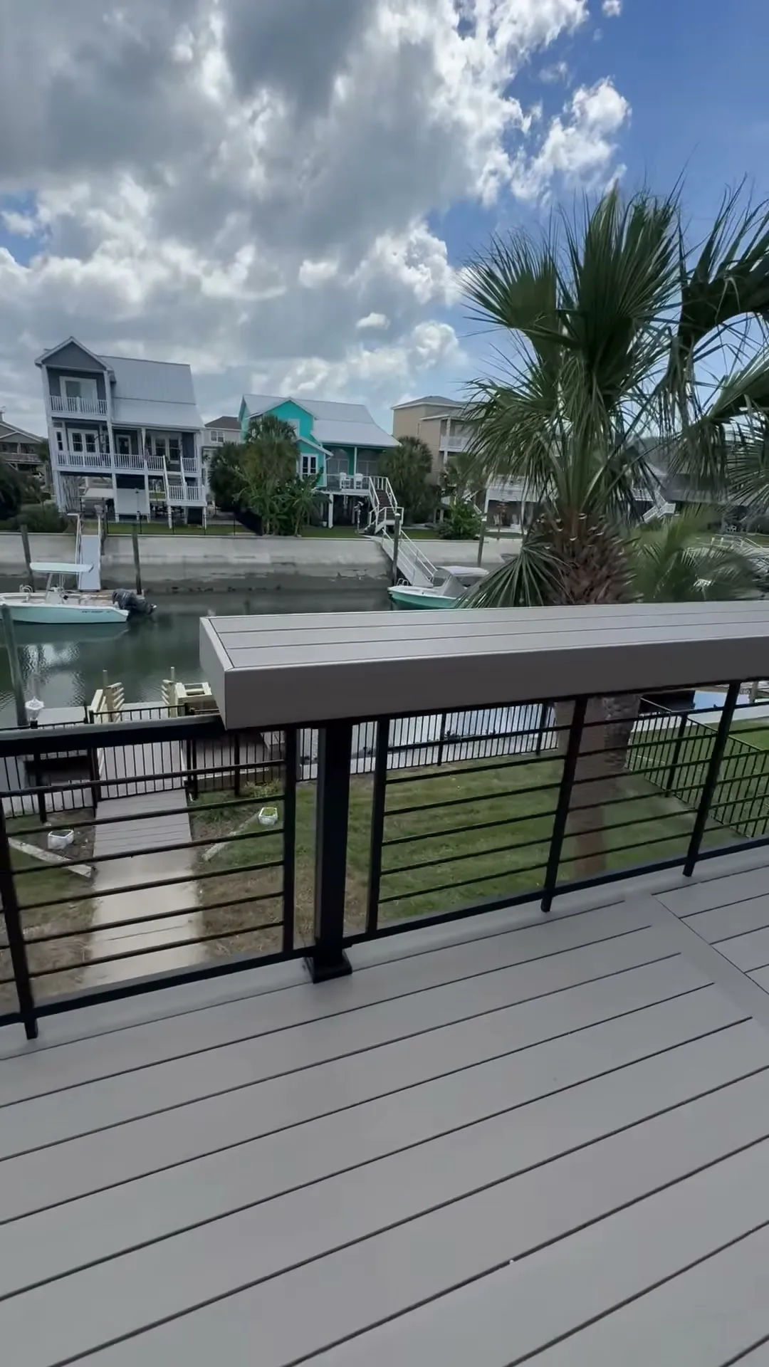 New composite deck with black aluminum rail overlooking the canal