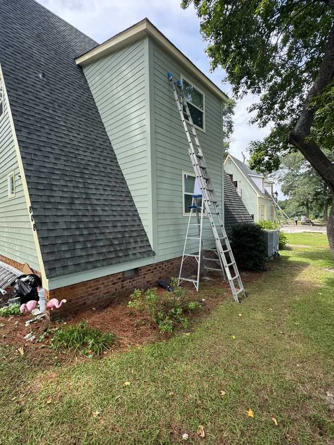 Siding installation in progress on a gable wall