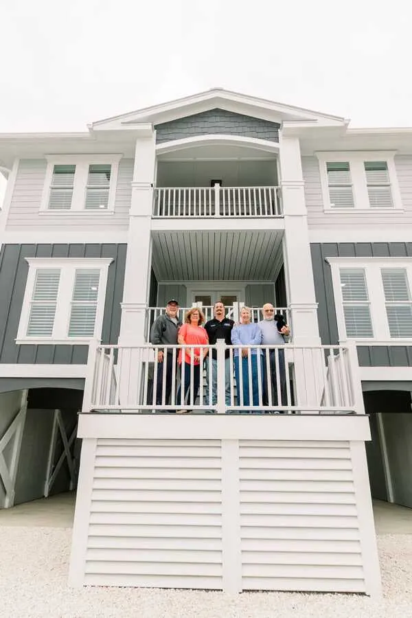 The Harden Construction Group team on the deck of a finished beach home
